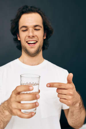 handsome man transparent glass of water health Lifestyle unalteredの写真素材