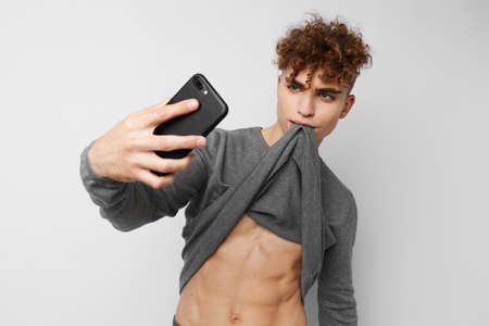 handsome guy with a phone in hand communication isolated backgroundの写真素材