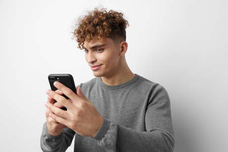 guy with a phone in hand communication isolated backgroundの写真素材