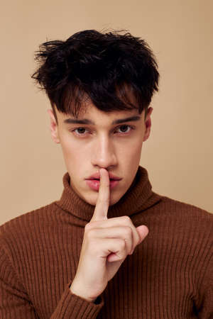 A young man fashionable clothes posing studio modern style light background unalteredの写真素材