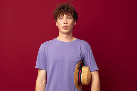 kinky guy red hair in casual wear Youth Style Studio red background unalteredの写真素材