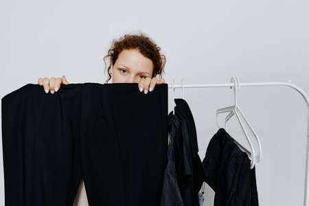 portrait of a young woman In a light classic suit clothes hanger isolated backgrounds unalteredの写真素材