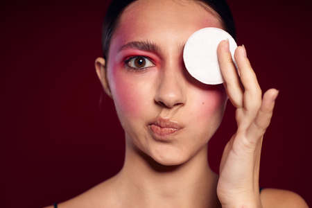 pretty woman cotton pads clean leather bright makeup posing cropped view unalteredの写真素材