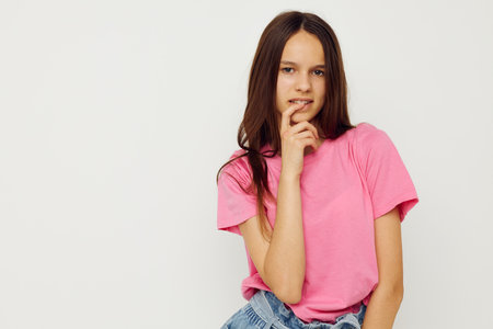 positive woman in a pink t-shirt casual clothes pink backgroundの写真素材