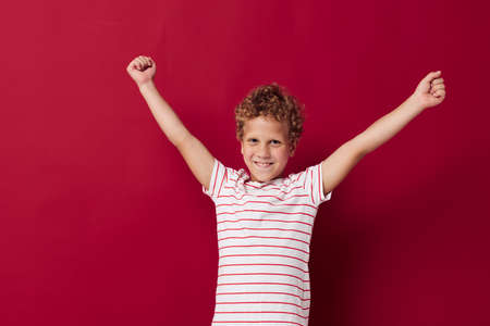 photo of a boy with curly hair in casual clothes emotionsの写真素材