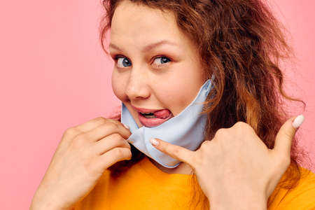 funny girl in a yellow t-shirt medical mask protection Lifestyle unalteredの写真素材
