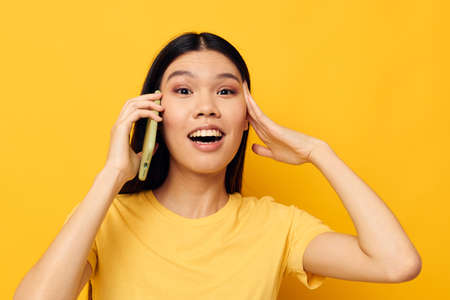 woman with Asian appearance talking on the phone posing technology Monochrome shotの写真素材