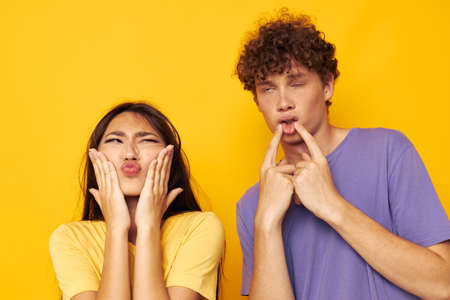 portrait of a man and a woman casual clothes posing emotions antics isolated background unaltered