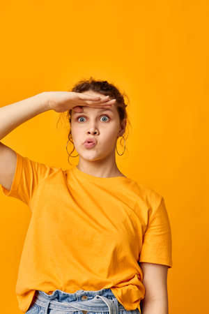 portrait of a young woman summer style yellow tshirt posing isolated backgrounds unaltered
