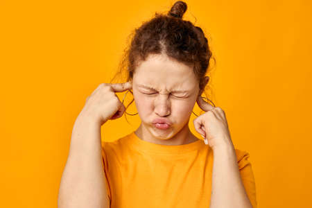 pretty girl fun earrings grimace hand gesture Youth style isolated backgrounds unalteredの写真素材