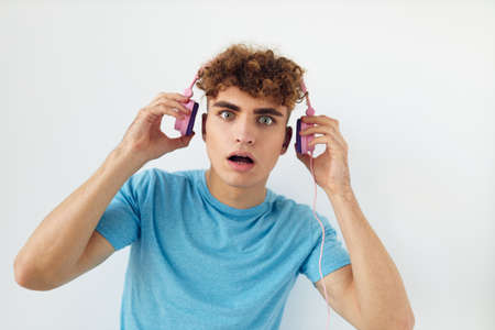 Attractive man in pink headphones music emotions isolated background