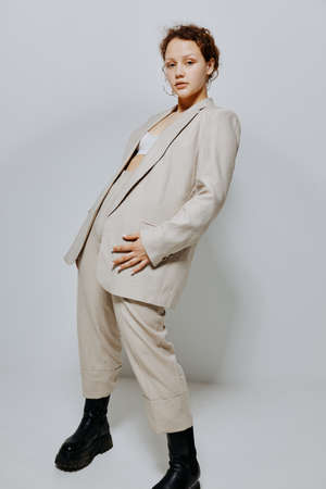cheerful woman In a light classic suit hand gesture light background unaltered