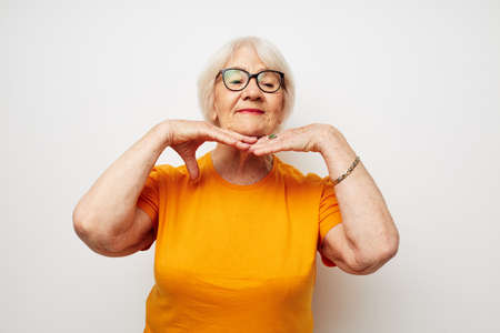 elderly woman in casual t-shirt and glasses isolated background