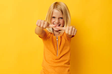 portrait of a little girl blonde straight hair posing smile fun isolated background unalteredの写真素材