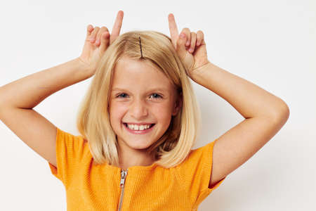 girl with blond hair gesture with hands posing close-upの写真素材