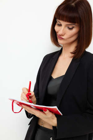 beautiful woman short haired red notepad and pencil isolated backgroundの写真素材