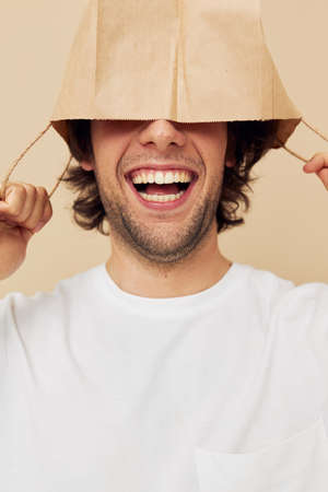 handsome man paper grocery bag posing isolated backgroundの写真素材