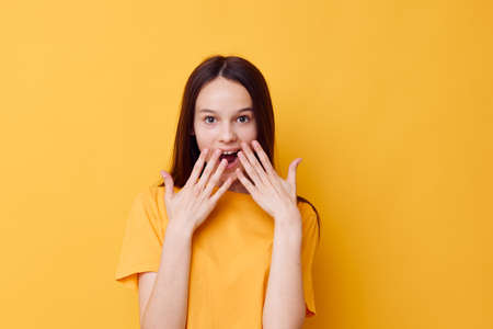 beautiful girl in a yellow t-shirt emotions summer style yellow background