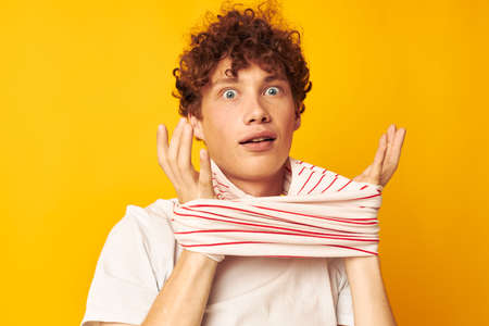 Young curly-haired man striped t shirt posing summer clothing Lifestyle unaltered