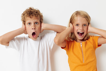 Portrait of cute children hand gestures fun childhood lifestyle unaltered
