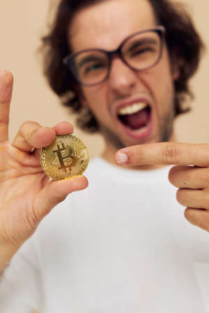 man with glasses gold bitcoin in hands Lifestyle unalteredの写真素材