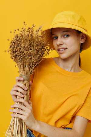 beautiful girl in a yellow t-shirt flax bouquet emotions summer style Lifestyle unaltered