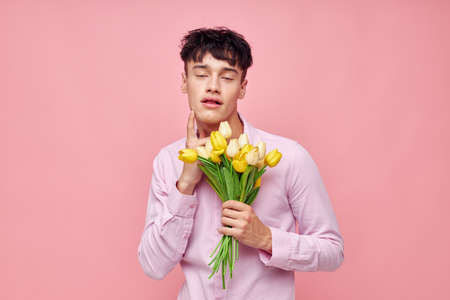 pretty man Bouquet of yellow flowers romance posing fashion isolated background unalteredの写真素材