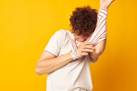 guy with red curly hair striped t shirt posing summer clothing isolated background unalteredの写真素材