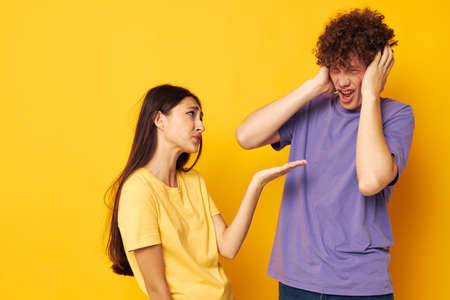 portrait of a man and a woman Friendship posing fun studio yellow background unaltered