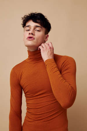 A young man stylish hairstyle brown turtleneck isolated background unalteredの写真素材