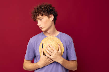 young guy red hair in casual wear Youth Style Studio red background unaltered