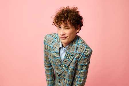 Young curly-haired man gesturing with his hands emotions checkered jacket Lifestyle unalteredの写真素材