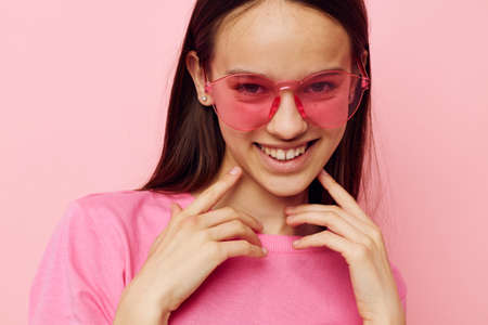 positive woman pink glasses and t-shirt hand gesture isolated backgroundの写真素材