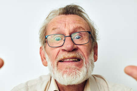 elderly man smile emotion hand gesture light backgroundの写真素材