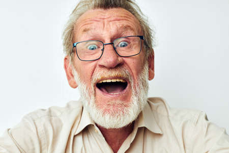 Photo of retired old man with a gray beard in a shirt and glasses unalteredの写真素材