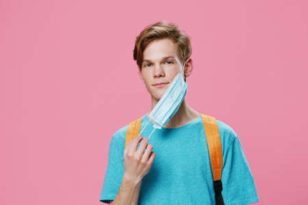 handsome, cute student guy took off his medical mask since the pandemic is overの写真素材
