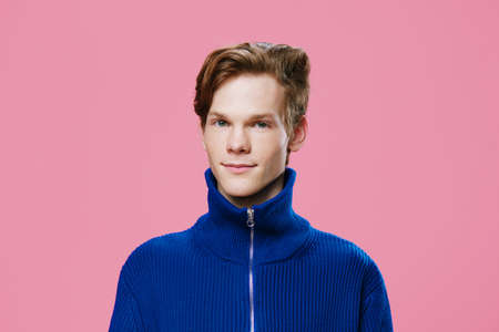 portrait of a handsome, sweet, nice guy in a blue zip-up jacket
