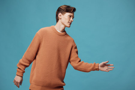 a man posing on a blue background in a dynamic pose with space for text