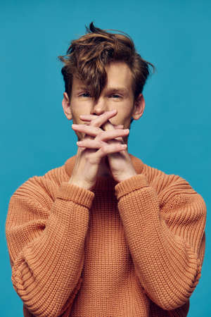 portrait of a man with hands near his faceの写真素材