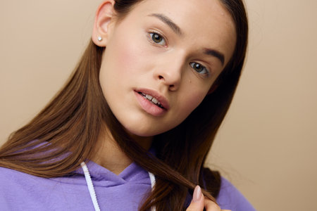 a close, horizontal, studio photo of a beautiful, pleasant, relaxed woman with neat daytime makeup...