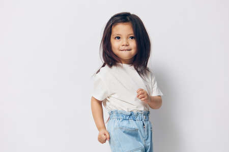 funny happy girl posing on light backgroundの写真素材