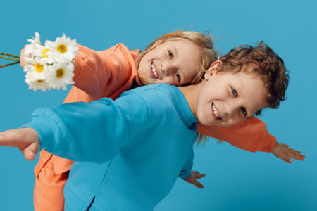 cute children, brother and sister stand sideways to the camera and the fool, the boy rolls the girl...