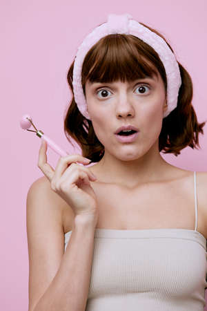 vertical beauty photo of a funny,shocked woman with short hair tucked behind a soft headband and...