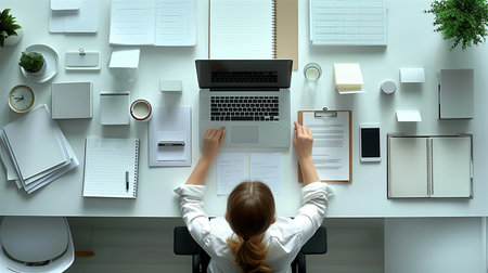 Overhead view of Young female creative designer working on the workspace deskの素材