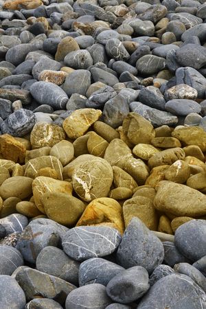 an interesting color pattern through rocks on the beachの写真素材