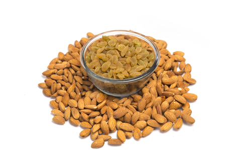 Almonds and raisins in glass bowl.の写真素材