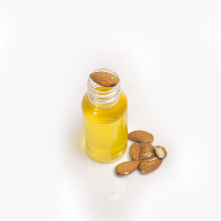 Almonds, oil in bottle on white background.の写真素材