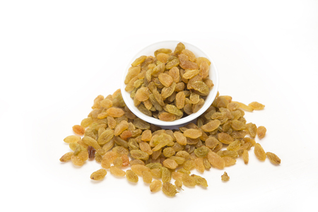 Sweet raisins with bowl. Isolated on white backgroundの写真素材