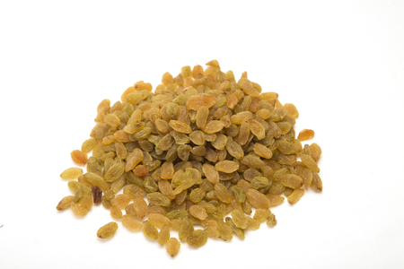Dried raisins heap on white background.の写真素材