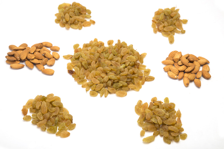 Pile of almonds and raisins in different on white backgroundの写真素材